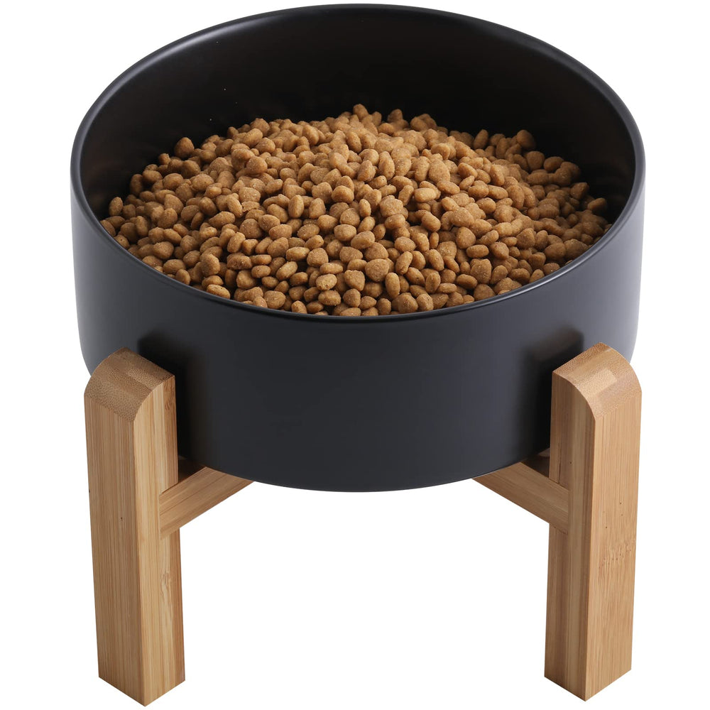 Addogyy black elevated ceramic dog bowl with wood stand for easy access at mealtime.