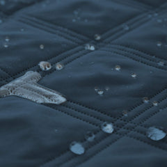 Ameritex waterproof dog bed cover folded, illustrating versatile blanket use on beds.