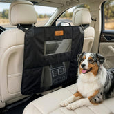 AnimoGoods dog car barrier mounted between front seats for secure travel.
