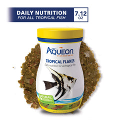 Aqueon Tropical Fish Flakes floating on water for easy surface feeding.