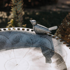 Backyard Expressions weather-resistant resin bird bath withstands outdoor conditions.