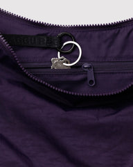 BAGGU Medium Nylon Crescent Bag Fig close-up highlighting durable recycled fabric.
