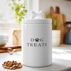 Barnyard Designs ceramic dog treat jar featuring a bone-shaped lid handle.