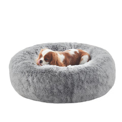 BedStill dark grey donut dog bed with raised sides for comforting rest.