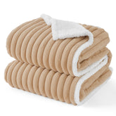 Bedsure ComfyFleece waterproof dog blanket on sofa protects furniture from spills and fur.