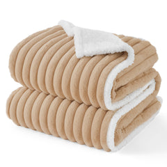 Bedsure ComfyFleece waterproof dog blanket on sofa protects furniture from spills and fur.