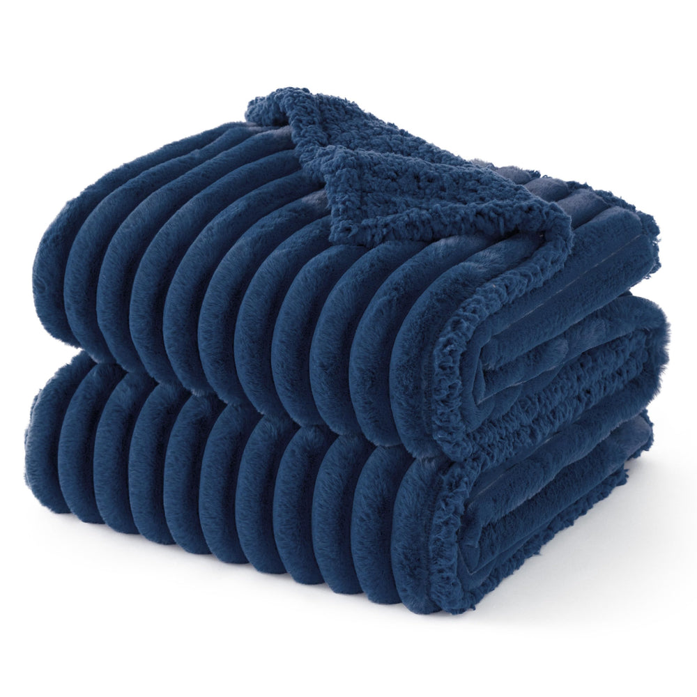 Bedsure ComfyFleece waterproof dog blanket on navy couch protects furniture