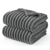 Bedsure ComfyFleece waterproof-dog-blanket on a couch protects furniture from spills and fur