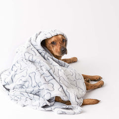 Folded in a crate, the Bone Dry blanket keeps pets snug and contained.