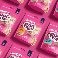 Cat enjoying Bonkers Purrpops treat, ideal bonding moment during snack time.