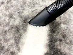 Buff Brite Fur Remover PRO II attached to vacuum capturing hair from carpet