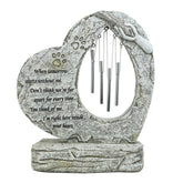 Carchistan dog memorial stone with wind chimes for outdoor remembrance.