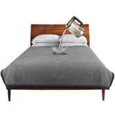 Catalonia waterproof blanket on a bed protecting against spills and stains