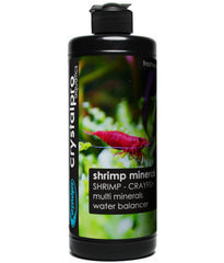 Crystalpro Shrimp Minerals bottle pouring into a freshwater tank for balanced minerals.