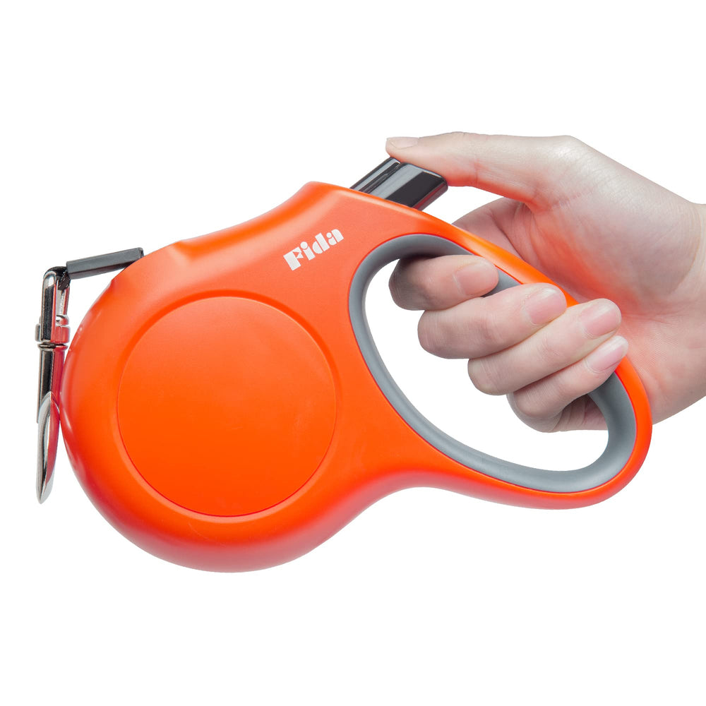 Fida retractable leash 16ft orange, clip and reel in action for extended control.