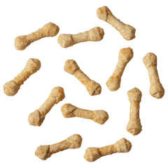 Dog enjoying Fieldcrest Farms Ultra Knotted Bone chicken chew for focused chewing.