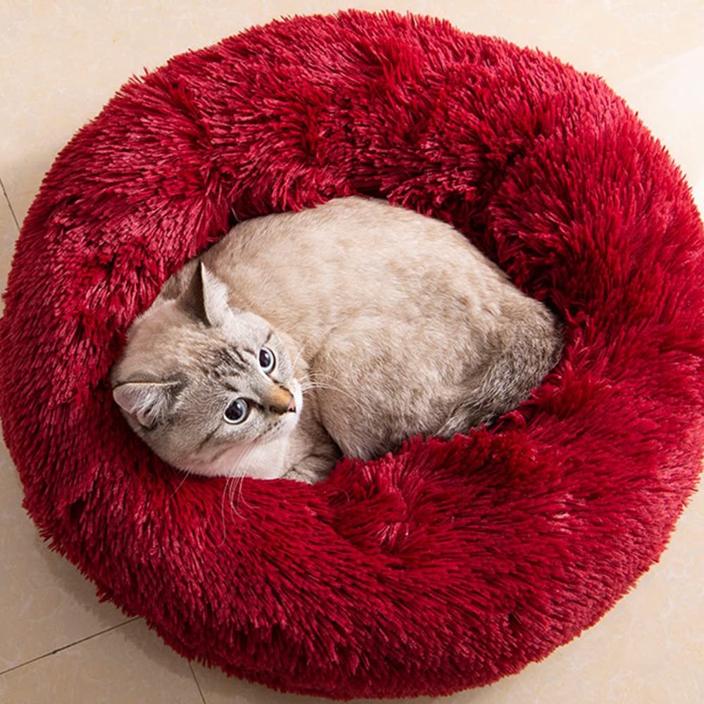 Generic cat bed round donut in red faux fur close-up for plush warmth
