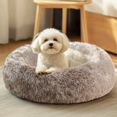 JOLLYVOGUE donut bed with plush fabric delivers cozy comfort for pets.