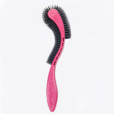 KittyWand cat brush with pink ergonomic handle for comfortable grooming.