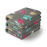 Luciphia paw-printed large grey throw on sofa showing pet-friendly protection and style