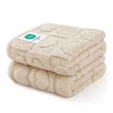 Luciphia small dog blanket on sofa protecting furniture with plush beige fleece.