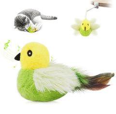 Migipaws Amakihi bird toy on the ground beside a curious cat inviting interactive play