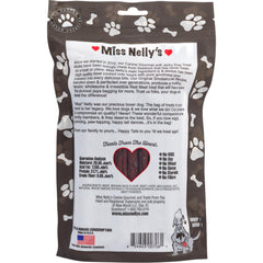 A dog happily chews Miss Nelly's jerky during training session.