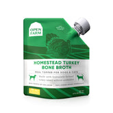 Open Farm bone broth bottle front with clear labeling for dogs and cats.