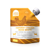 Open Farm Chicken Bone Broth bottle shown on countertop, ready to top pet meals.