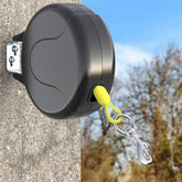 PAWSTATION 30ft wall-mount retractable dog tie-out cable enables spacious yard play.