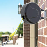 PAWSTATION 30ft wall-mount retractable tie-out cable in outdoor use for safe yard exploration