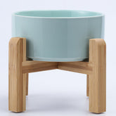 Petygooing elevated bowl with wood stand on blue sky, promoting comfortable feeding