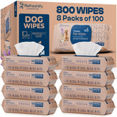 REFRESHIFY dog wipes on paws after an outdoor adventure.
