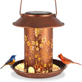 Tepaken bird feeder lantern in the garden, adding evening ambiance and light.