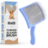 We Love Doodles curved slicker brush on long-haired dogs for detangling and smoothing fur.