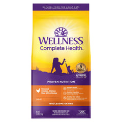 Wellness Complete Health chicken kibble close-up in a 5-pound bag, real chicken first ingredient