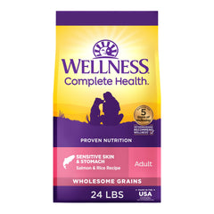 Wellness Complete Health dog food front packaging with salmon and rice for sensitive skin and stomach.