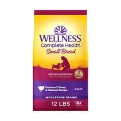 Wellness Complete Health small breed kibble close-up highlighting turkey and oatmeal nutrition.