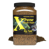 Xtreme Aquatic Foods Big Fella 3mm pellets in feeding dish; protein-rich for large cichlids.