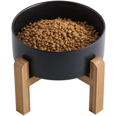 Addogyy black elevated ceramic dog bowl with wood stand for easy access at mealtime.