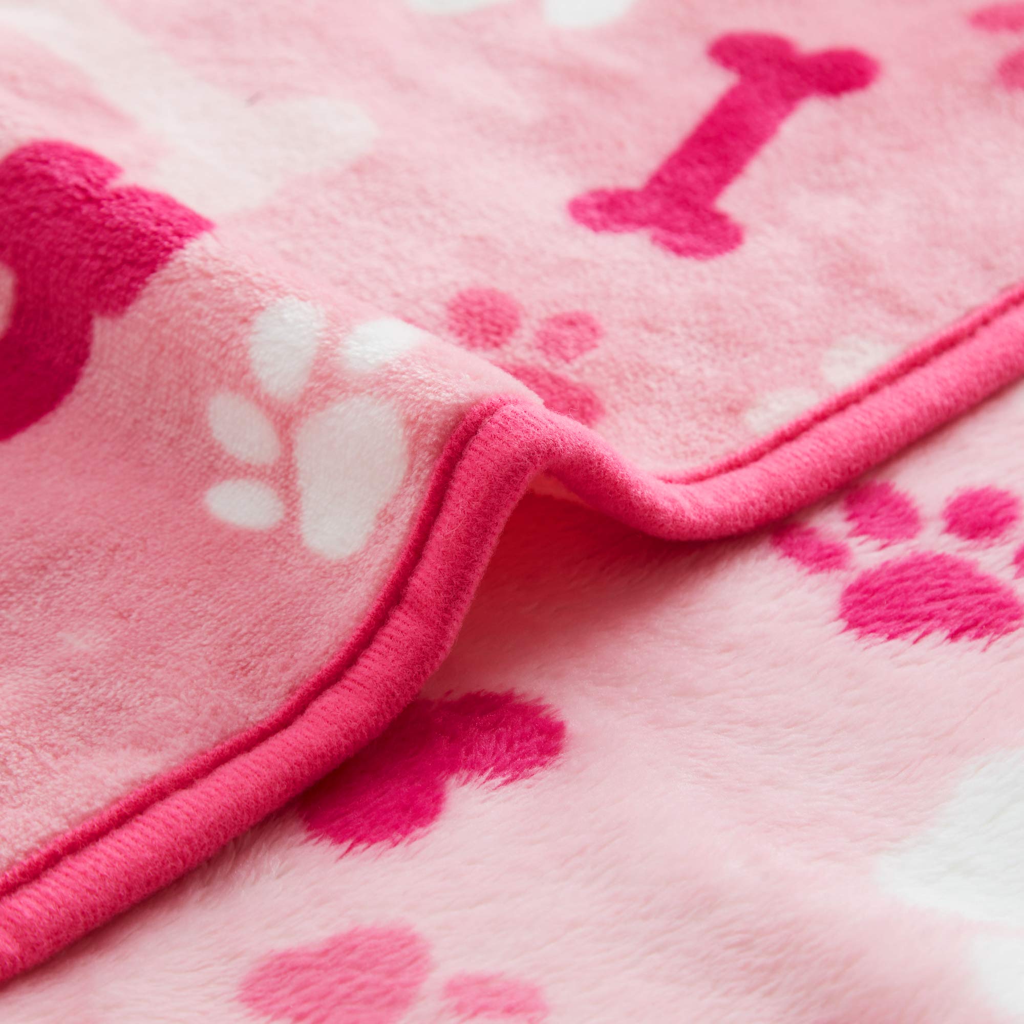 Allisandro pink paw bone design blanket adds playful style for pets.