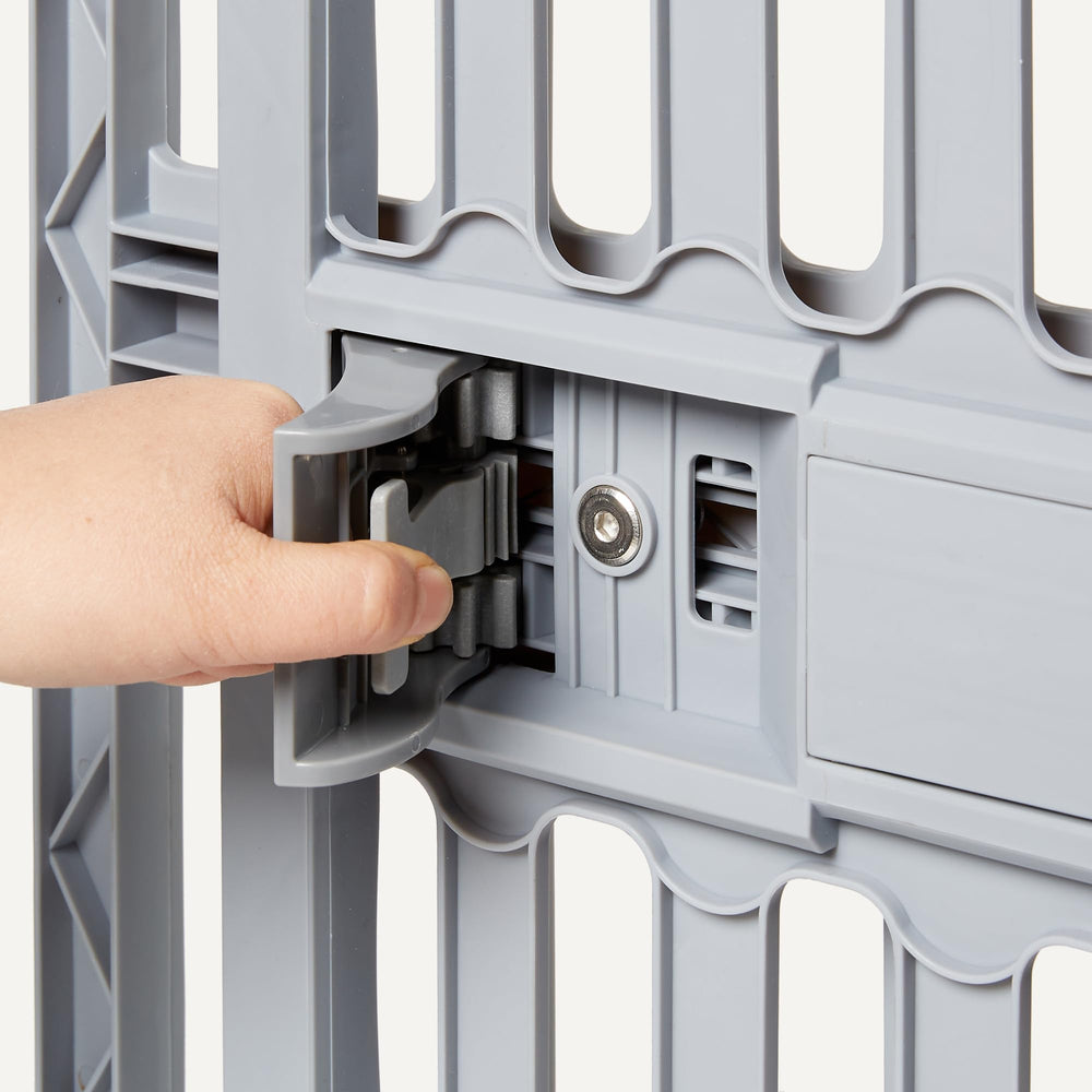 Amazon Basics gate secured with four plastic screws for stable placement