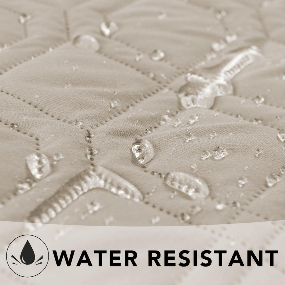 Ameritex furniture cover on sofa edge provides waterproof protection from spills.