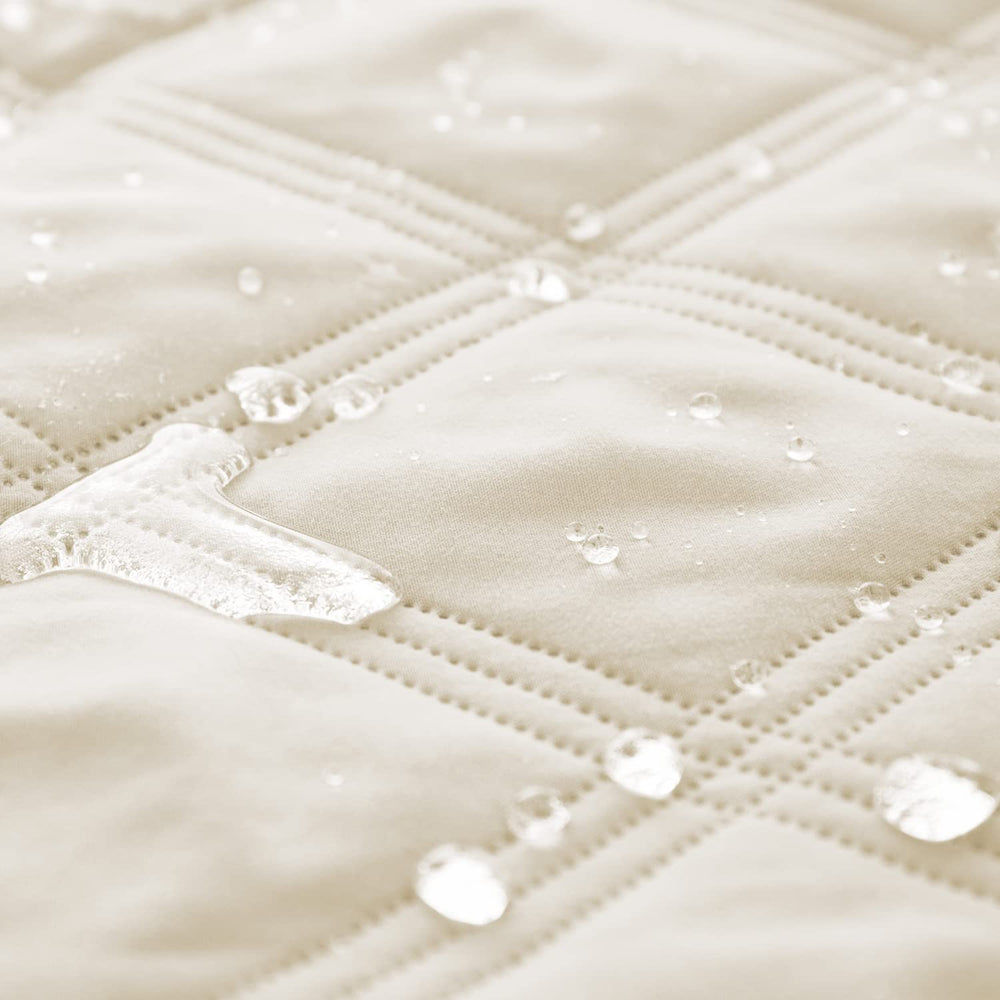 Ameritex waterproof dog bed cover on sofa protects upholstery from accidents.