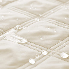 Ameritex waterproof dog bed cover on sofa protects upholstery from accidents.