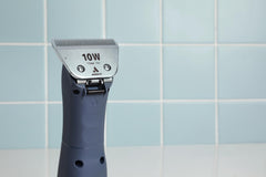 Andis detachable wide blade clipper enables quick blade changes during sessions.