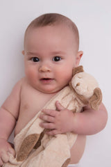 Angel Dear light brown puppy blankie in a nursery setting for on-the-go companionship.