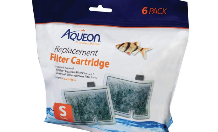 Aqueon filter cartridge being rinsed under water to remove carbon dust before installation.