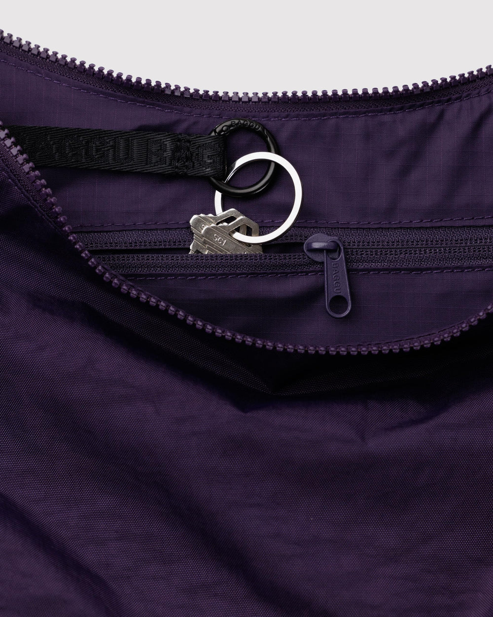 BAGGU Medium Nylon Crescent Bag Fig close-up highlighting durable recycled fabric.