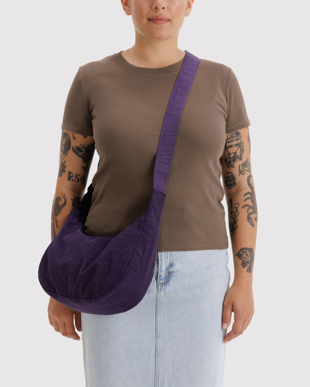 BAGGU Crescent Bag Fig side view showing compact profile and adjustable strap.